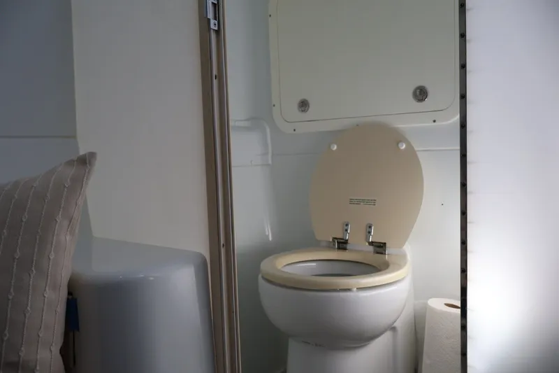 Slide: The Image of 2017 Yellowfin 42 Offshore boat bathroom with toilet and paper roll. - 26