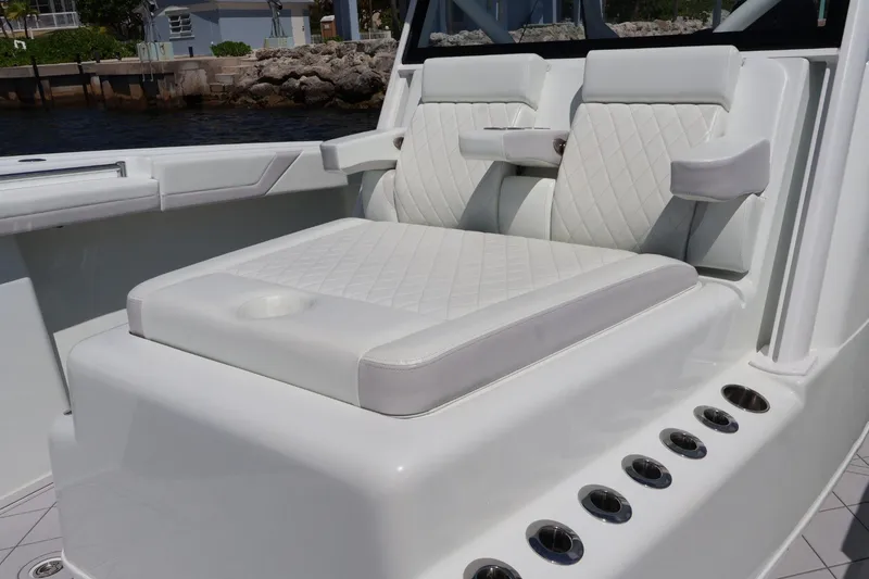 Slide: The Image of Luxurious seating on a 2017 Yellowfin 42 Offshore boat, featuring white quilted upholstery. - 16