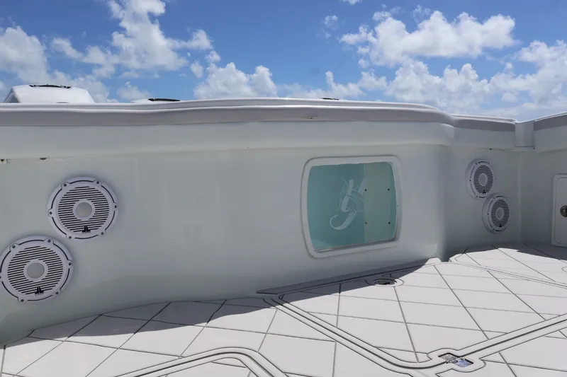 Slide: The Image of 2017 Yellowfin 42 Offshore boat deck with speakers under a clear blue sky. - 6