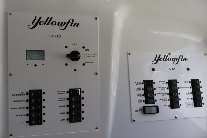 Slide: The Image of Control panels on a 2017 Yellowfin 42 Offshore boat, featuring 120VAC and 12V DC systems. - 25
