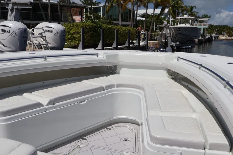 Slide: The Image of 2017 Yellowfin 42 Offshore boat with spacious seating and Yamaha engines docked by the water. - 21