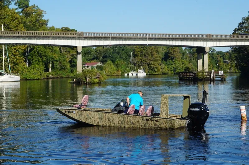 The Image of Boat on a river under a bridge, Lowe Outlet 20, 2025 model. - 0