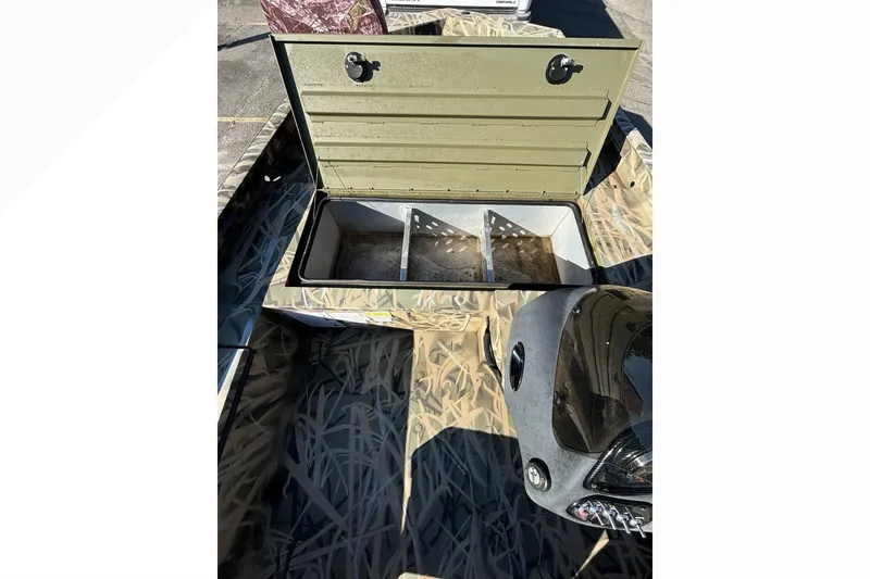 Slide: The Image of Open storage compartment in 2025 Lowe Outlet 20 boat with camouflage interior design. - 12