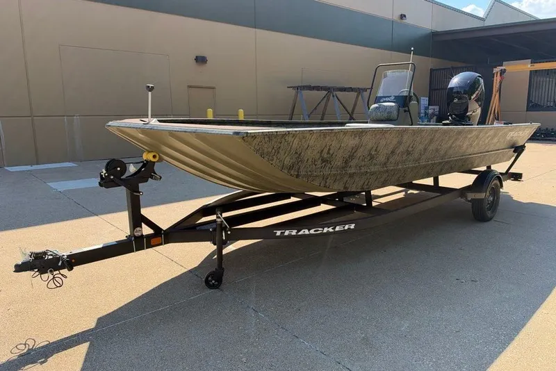 The Image of 2027 Tracker Grizzly 2072 CC boat on trailer, parked outdoors. - 0