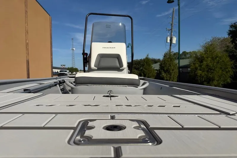 Slide: The Image of 2027 Tracker Bass Tracker Classic CC boat deck and seating, outdoor setting. - 13