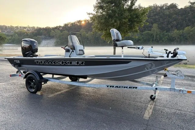 The Image of 2027 Tracker Bass Tracker 175 CC boat on trailer, parked near a misty lake. - 0