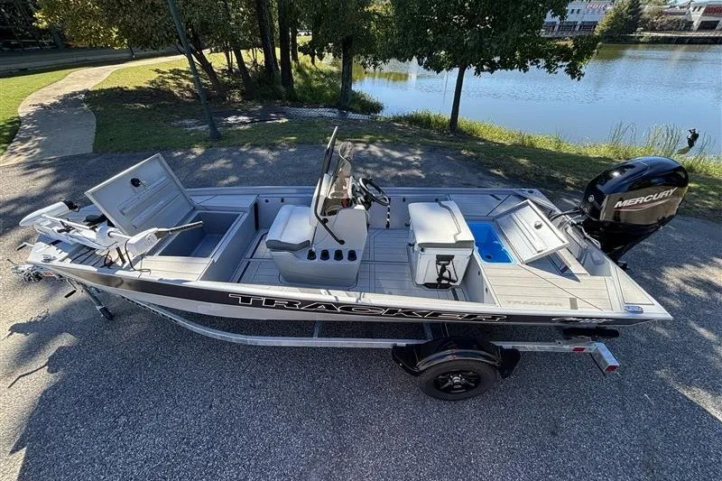 Slide: The Image of 2027 Tracker Bass Tracker Classic CC boat on trailer by a lake. - 13