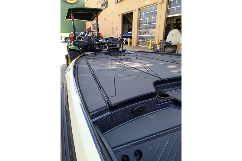 Slide: The Image of 2027 Nitro Z20 XL Pro boat deck, sleek design, parked outside a garage. - 7