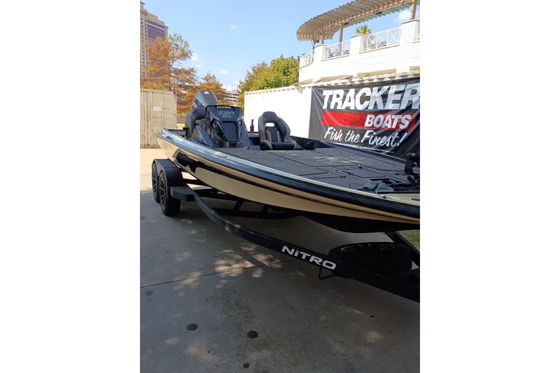 Slide: The Image of 2027 Nitro Z20 XL Pro boat on trailer, displayed outdoors near Tracker Boats sign. - 10