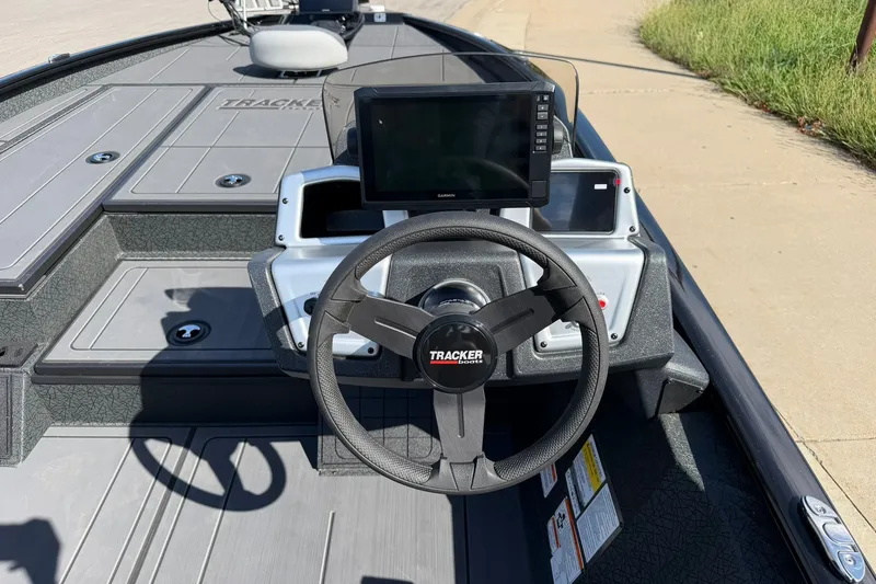 Slide: The Image of Steering console of 2027 Tracker Savage 215 boat with modern navigation display. - 16