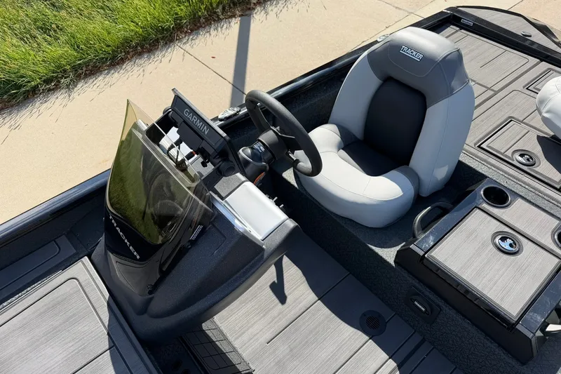 Slide: The Image of 2027 Tracker Savage 215 boat interior with Garmin navigation system and comfortable seating. - 27