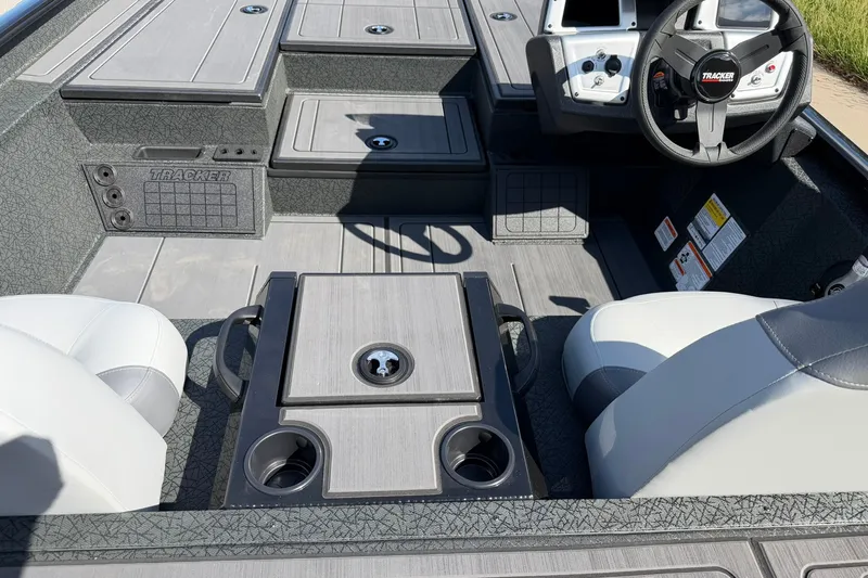 Slide: The Image of Interior of 2027 Tracker Savage 215 boat with steering wheel and seating. - 25