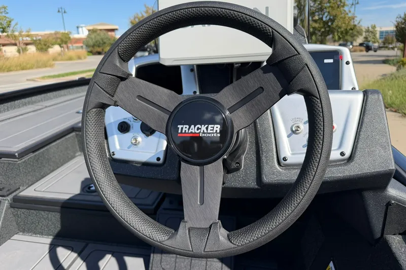 Slide: The Image of Steering wheel of 2027 Tracker Savage 215 boat, featuring sleek design and controls. - 19