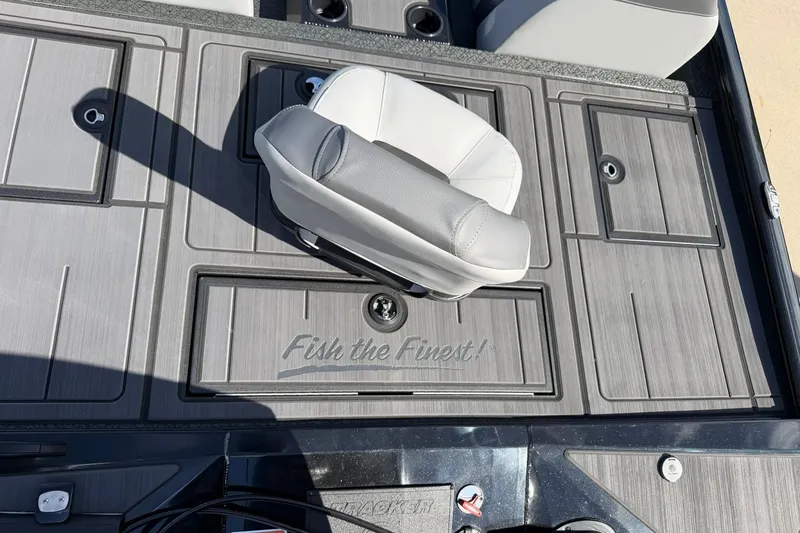 Slide: The Image of Deck of 2027 Tracker Savage 215 boat with seating and storage compartments. - 30