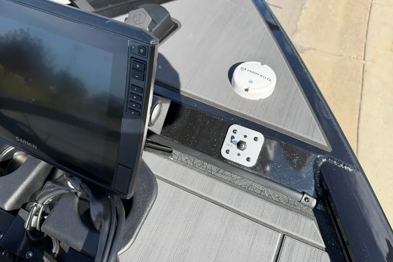 Slide: The Image of 2027 Tracker Savage 215 boat dashboard with Garmin display and Minn Kota device. - 22