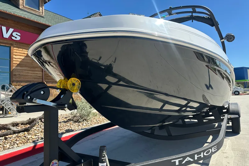 Slide: The Image of 2027 Tahoe T21 boat on trailer outside dealership, showcasing sleek design and modern features. - 4
