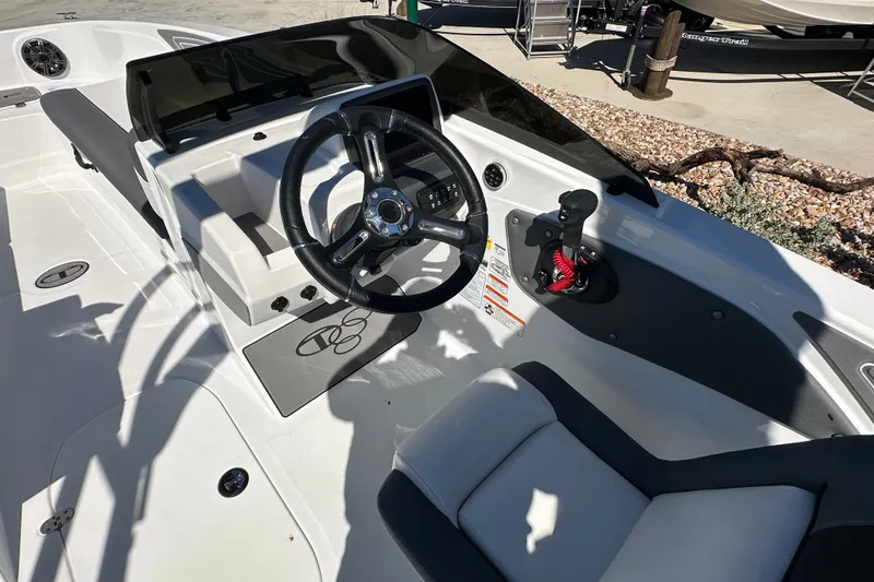 Slide: The Image of 2027 Tahoe T21 boat cockpit with steering wheel and control panel in sunlight. - 11