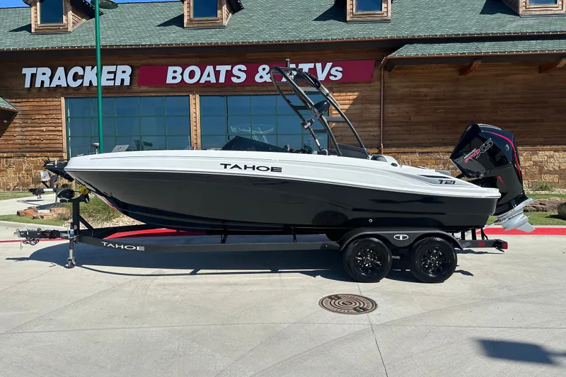 Slide: The Image of 2027 Tahoe T21 boat on trailer outside Tracker Boats store. - 1