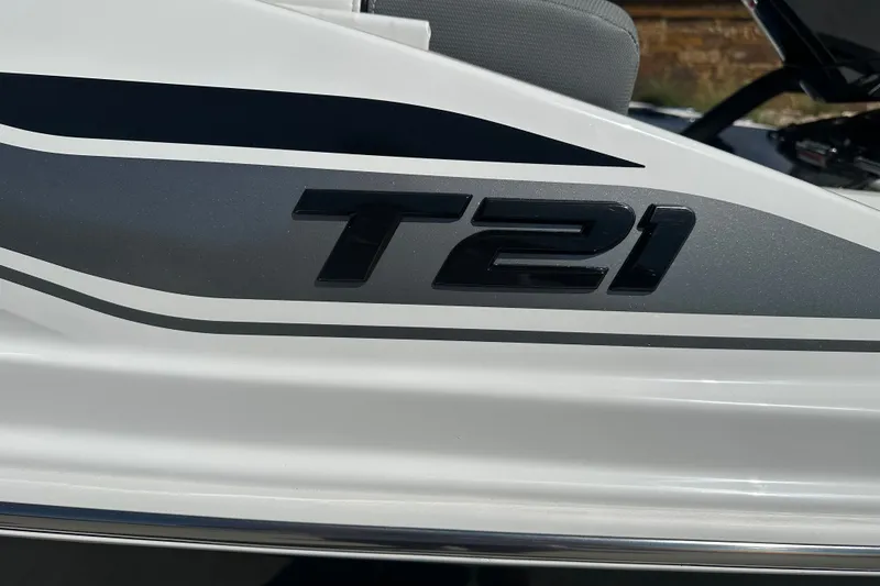 Slide: The Image of Close-up of 2027 Tahoe T21 boat model logo on sleek white surface. - 3