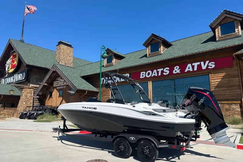 The Image of 2027 Tahoe T21 boat displayed outside a store with "Boats & ATVs" signage. - 0