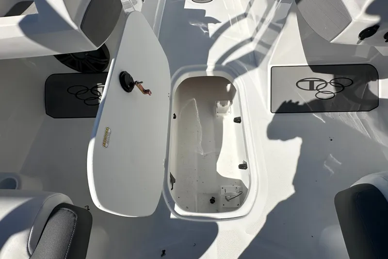 Slide: The Image of Open storage compartment in 2027 Tahoe T21 boat interior, featuring sleek design and seating. - 13