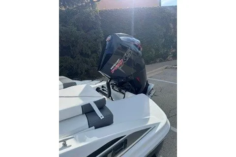 Slide: The Image of 2027 Tahoe T21 boat with powerful outboard motor in a sunny outdoor setting. - 15