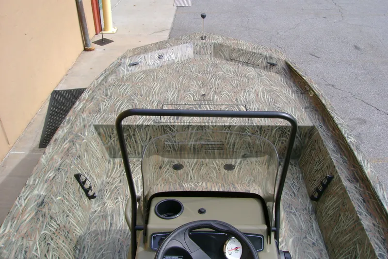 Slide: The Image of 2027 Tracker Grizzly 1860 CC boat with camouflage design and steering console. - 14