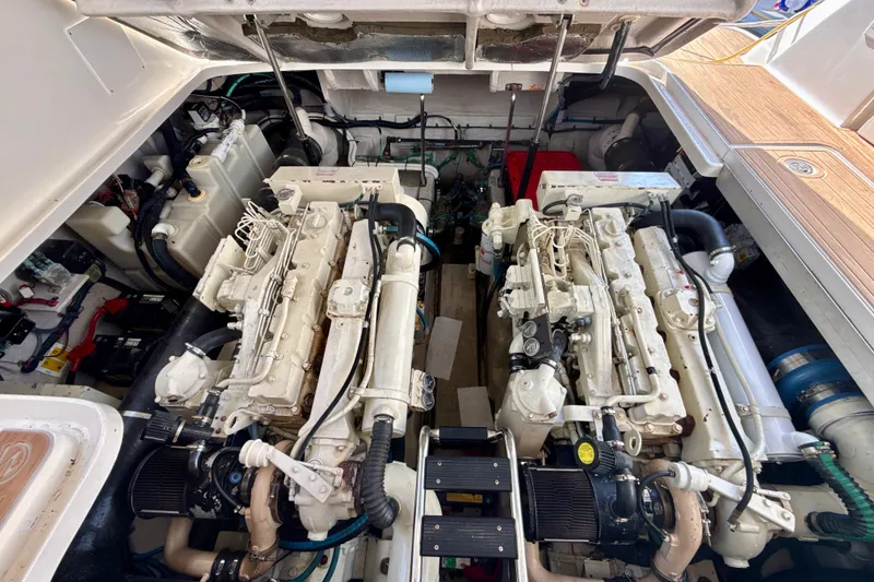 Slide: The Image of Engine room of a 2005 Sea Ray 420 Sundancer yacht, showcasing dual engines and mechanical components. - 29
