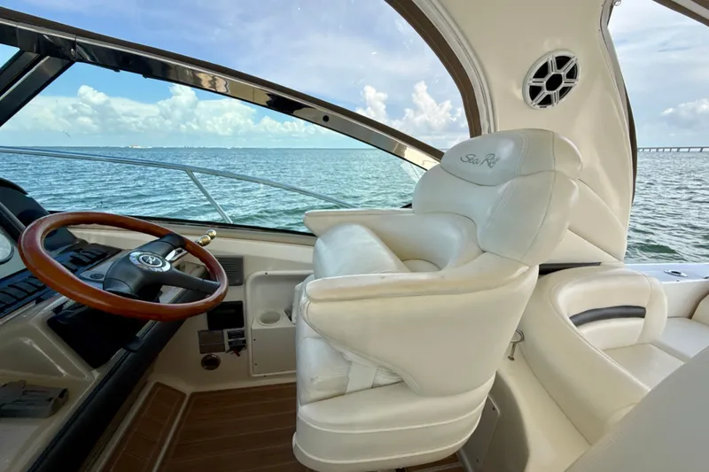 Slide: The Image of Interior view of 2005 Sea Ray 420 Sundancer yacht with luxurious seating and ocean backdrop. - 13