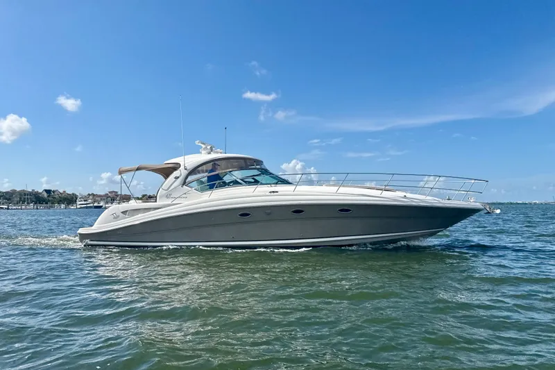 Slide: The Image of 2005 Sea Ray 420 Sundancer yacht cruising on a sunny day with clear blue skies. - 32