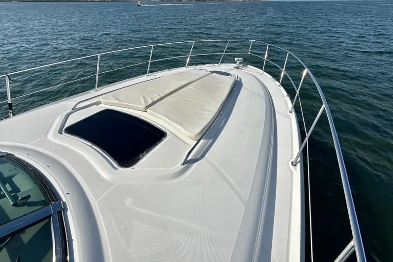 Slide: The Image of 2005 Sea Ray 420 Sundancer yacht deck with sunpad, cruising on open water. - 26