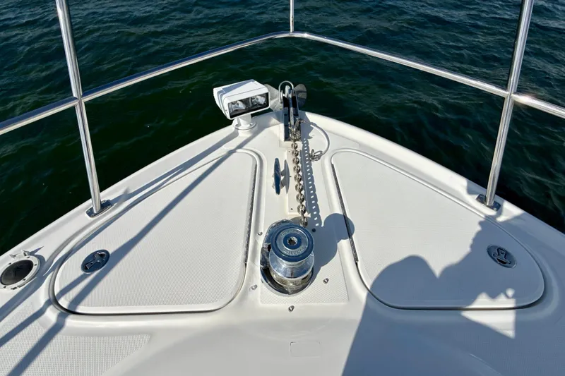 Slide: The Image of Bow of 2005 Sea Ray 420 Sundancer with anchor and railing, on calm water. - 28