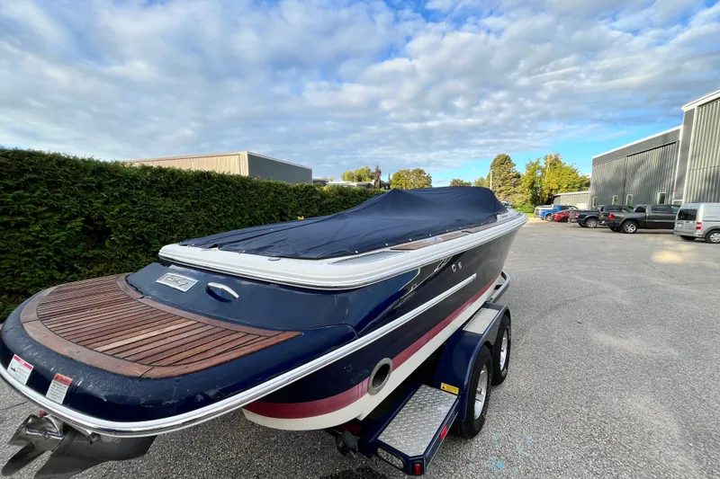 Slide: The Image of 2008 Chris-Craft Launch 22 boat on trailer, covered, parked outdoors. - 3