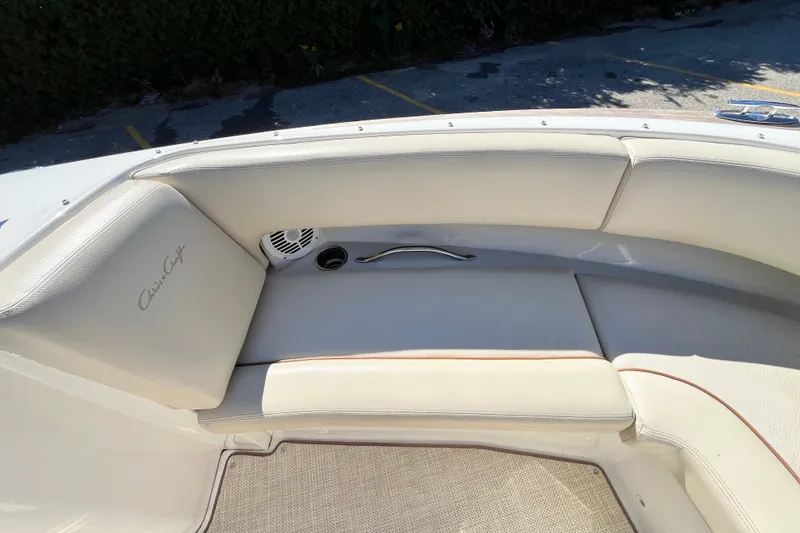 Slide: The Image of 2008 Chris-Craft Launch 22 boat interior with cream leather seating and speaker detail. - 6
