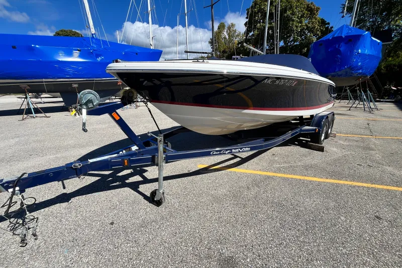 Slide: The Image of 2008 Chris-Craft Launch 22 boat on trailer in a marina setting. - 2
