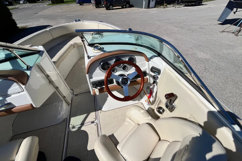 Slide: The Image of 2008 Chris-Craft Launch 22 boat interior with steering wheel and seating area. - 8