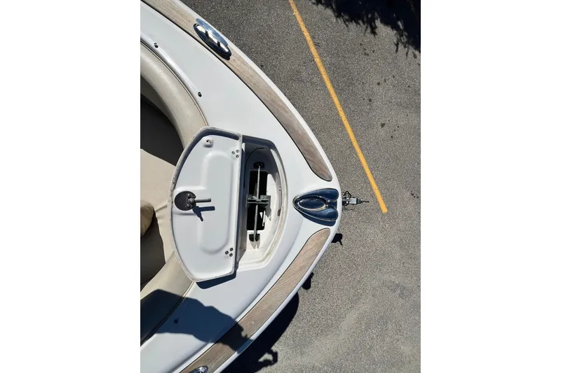 Slide: The Image of 2008 Chris-Craft Launch 22 boat bow with open hatch, parked on asphalt. - 7