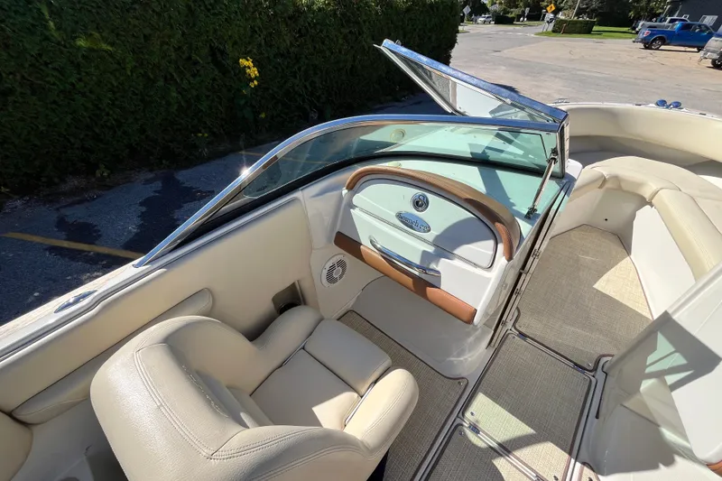 Slide: The Image of 2008 Chris-Craft Launch 22 boat interior with beige seating and steering console. - 9