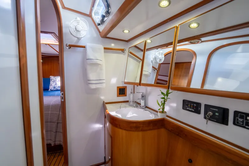 Slide: The Image of Luxurious 2004 Hylas 54 yacht bathroom with wood accents and modern fixtures. - 20