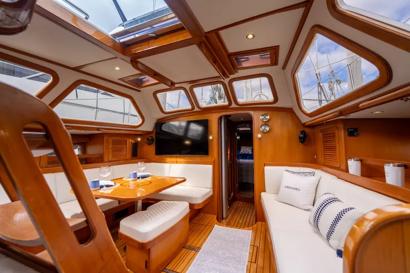 Slide: The Image of Luxurious 2004 Hylas 54 yacht interior with elegant wood finish and plush seating. - 13