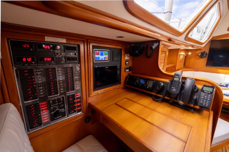Slide: The Image of Navigation station of a 2004 Hylas 54 yacht with control panels and communication devices. - 14