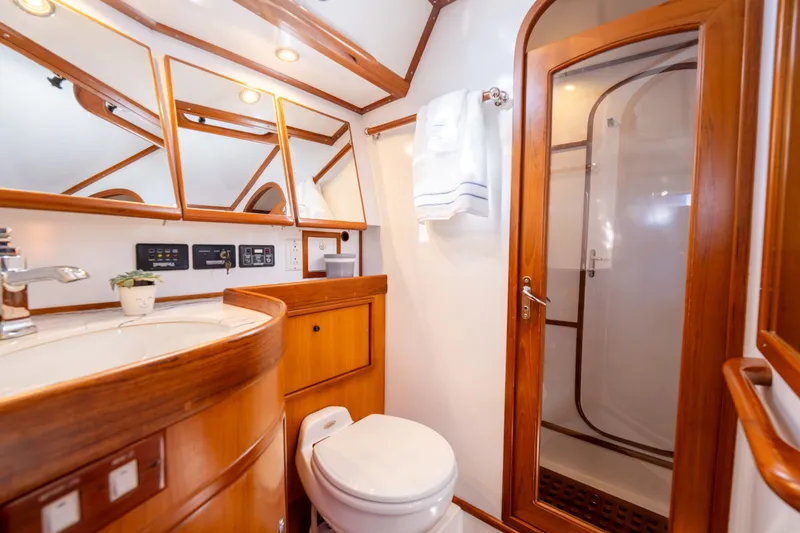 Slide: The Image of Luxurious 2004 Hylas 54 yacht bathroom with wooden accents and modern fixtures. - 19