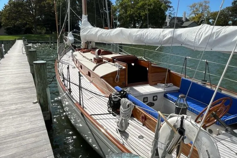 Slide: The Image of Vintage 1932 Nevins 46 Yawl docked, showcasing classic wooden design and rigging. - 5