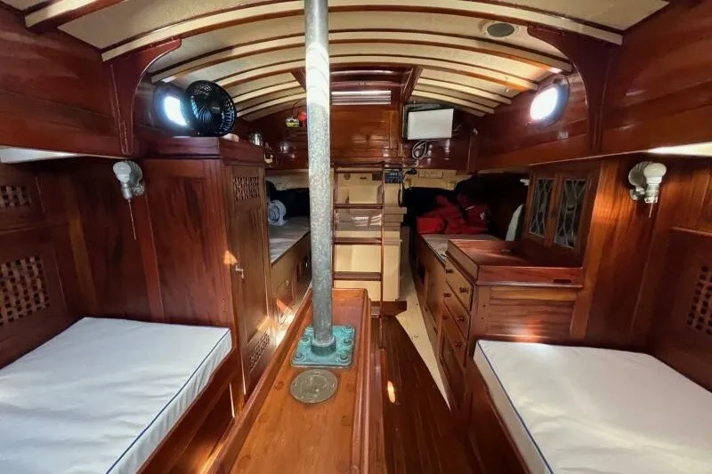 Slide: The Image of Interior of 1932 Nevins 46 Yawl, featuring polished wood and cozy berths. - 2
