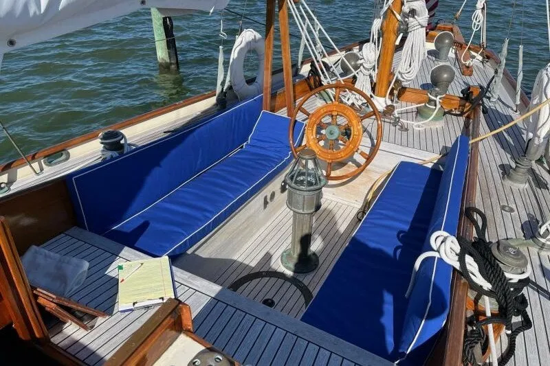 Slide: The Image of Cockpit of 1932 Nevins 46 Yawl with blue cushions and wooden steering wheel. - 4