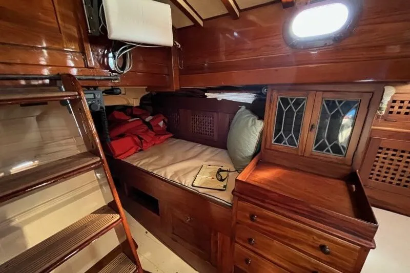 Slide: The Image of Cozy cabin interior of 1932 Nevins 46 Yawl with wooden furnishings and nautical decor. - 12