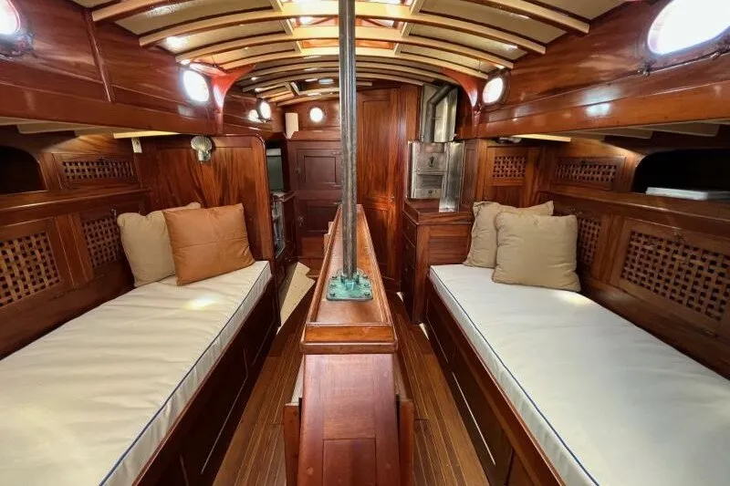 Slide: The Image of Interior of a 1932 Nevins 46 Yawl with wooden finishes and twin berths. - 3