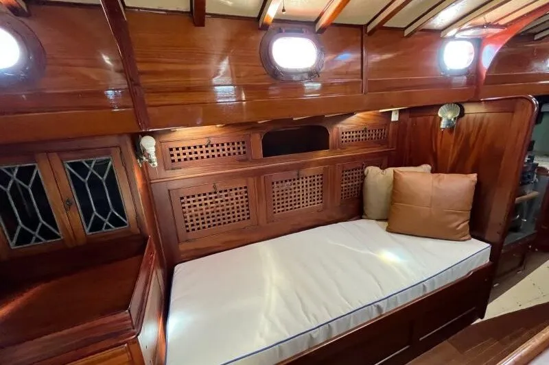 Slide: The Image of Interior of 1932 Nevins 46 Yawl, featuring polished wood and cozy seating area. - 10