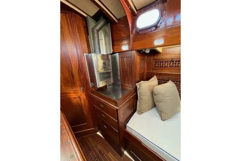 Slide: The Image of Interior of 1932 Nevins 46 Yawl, featuring wood paneling and a cozy cabin space. - 8