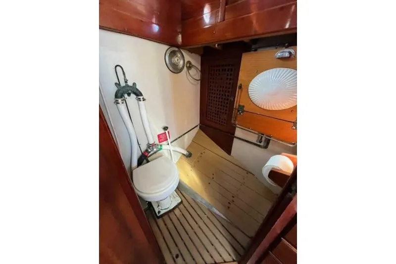Slide: The Image of Vintage 1932 Nevins 46 Yawl boat bathroom with wooden accents and nautical fixtures. - 9